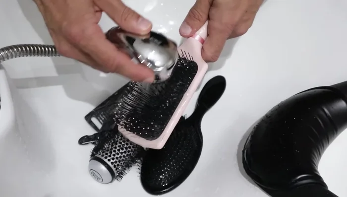 Rinse brushes again with hot water to remove debris.