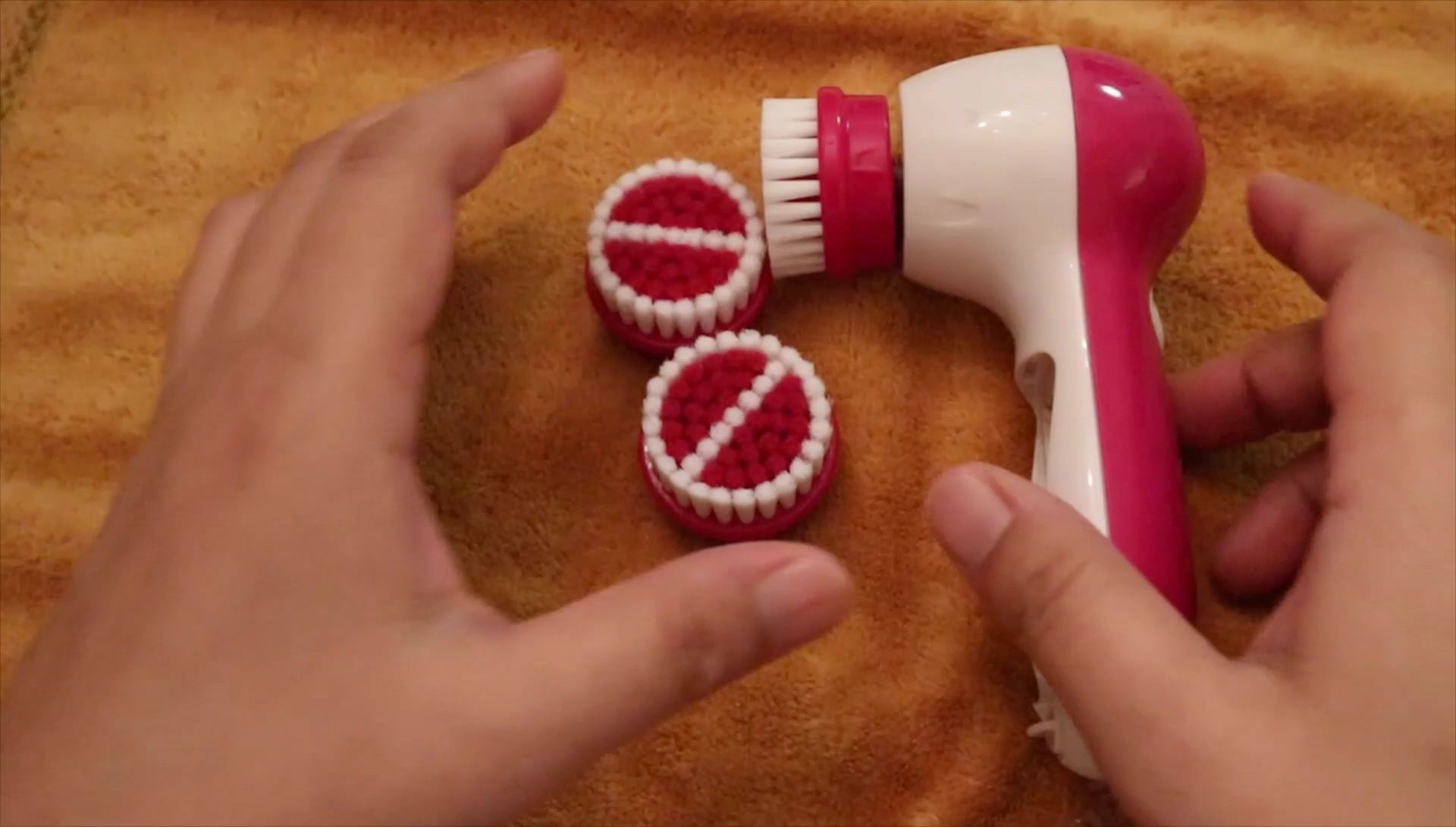 The reviewer demonstrating the use of the facial brush.