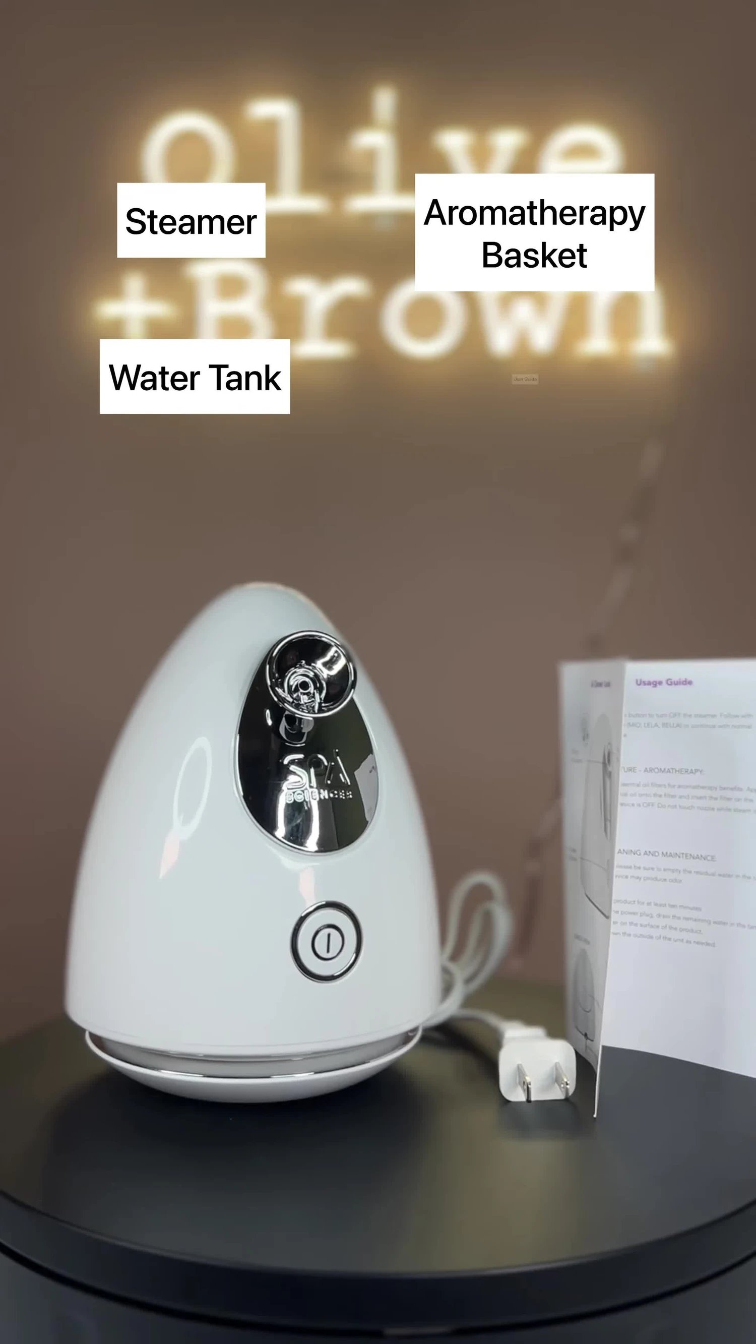 The steamer, aromatherapy basket, water tank and user guide laid out.