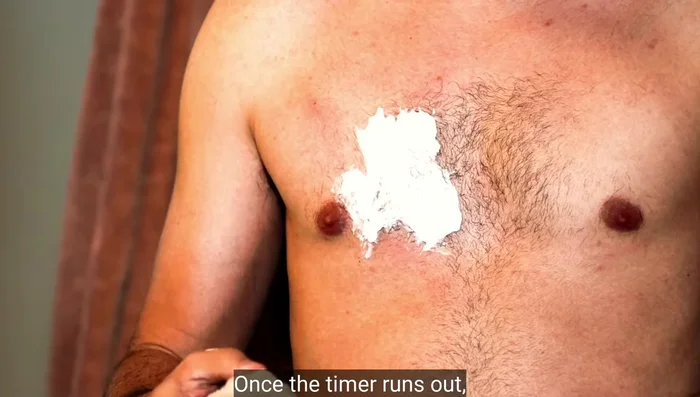 After the timer goes off, gently pull on a small section of the cream with a cloth or spatula to check if the hair pulls away easily. If not, wait another minute and repeat.