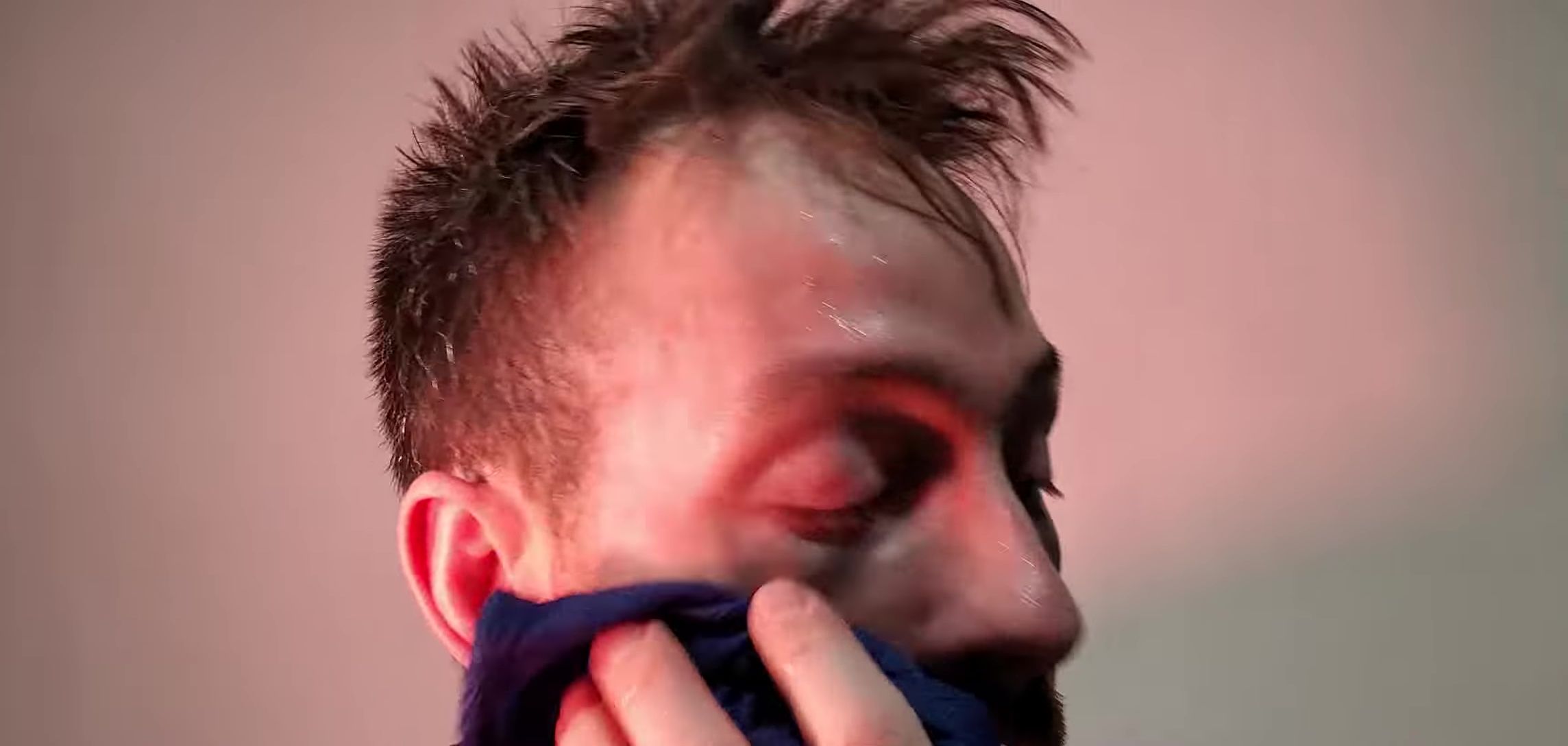 Applying water to the brush and face.