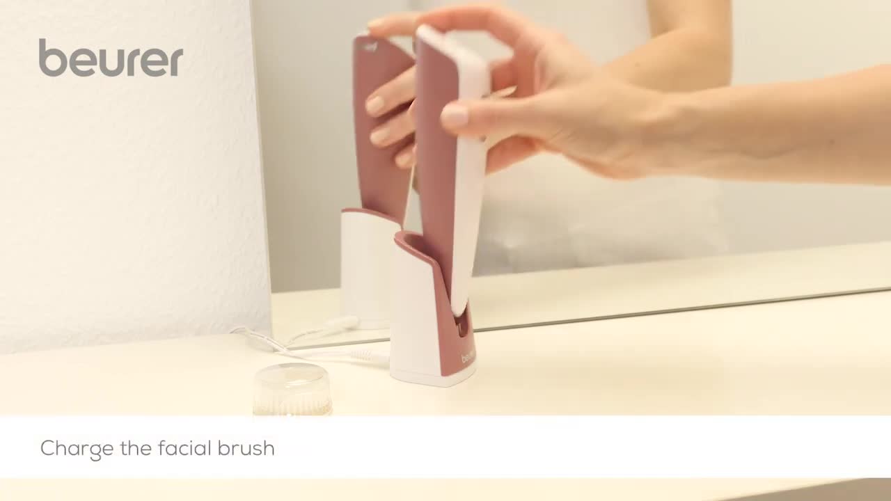 Inserting the Beurer FC 96 facial brush into the charger.