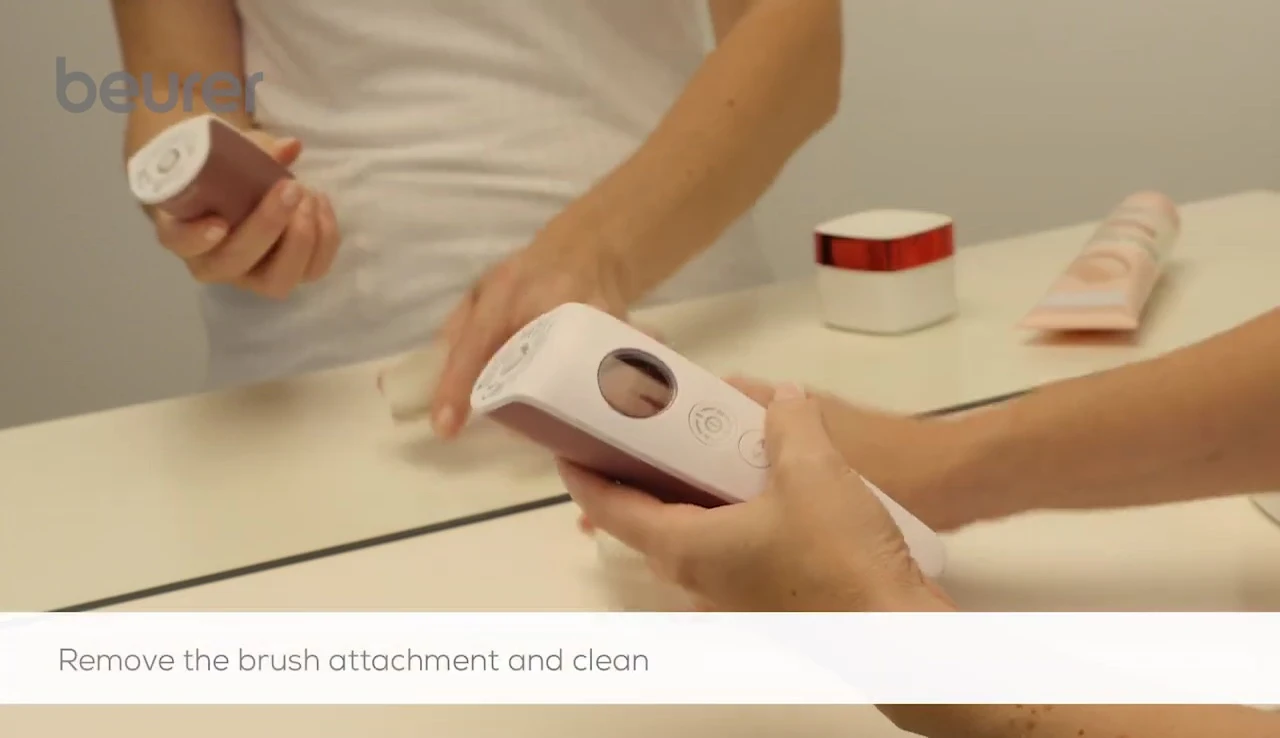 Removing the brush attachment after use.