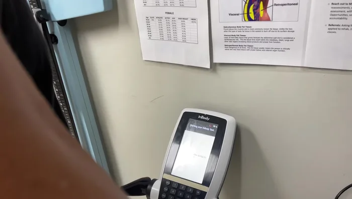 The machine will send a small current through your torso to measure body composition.