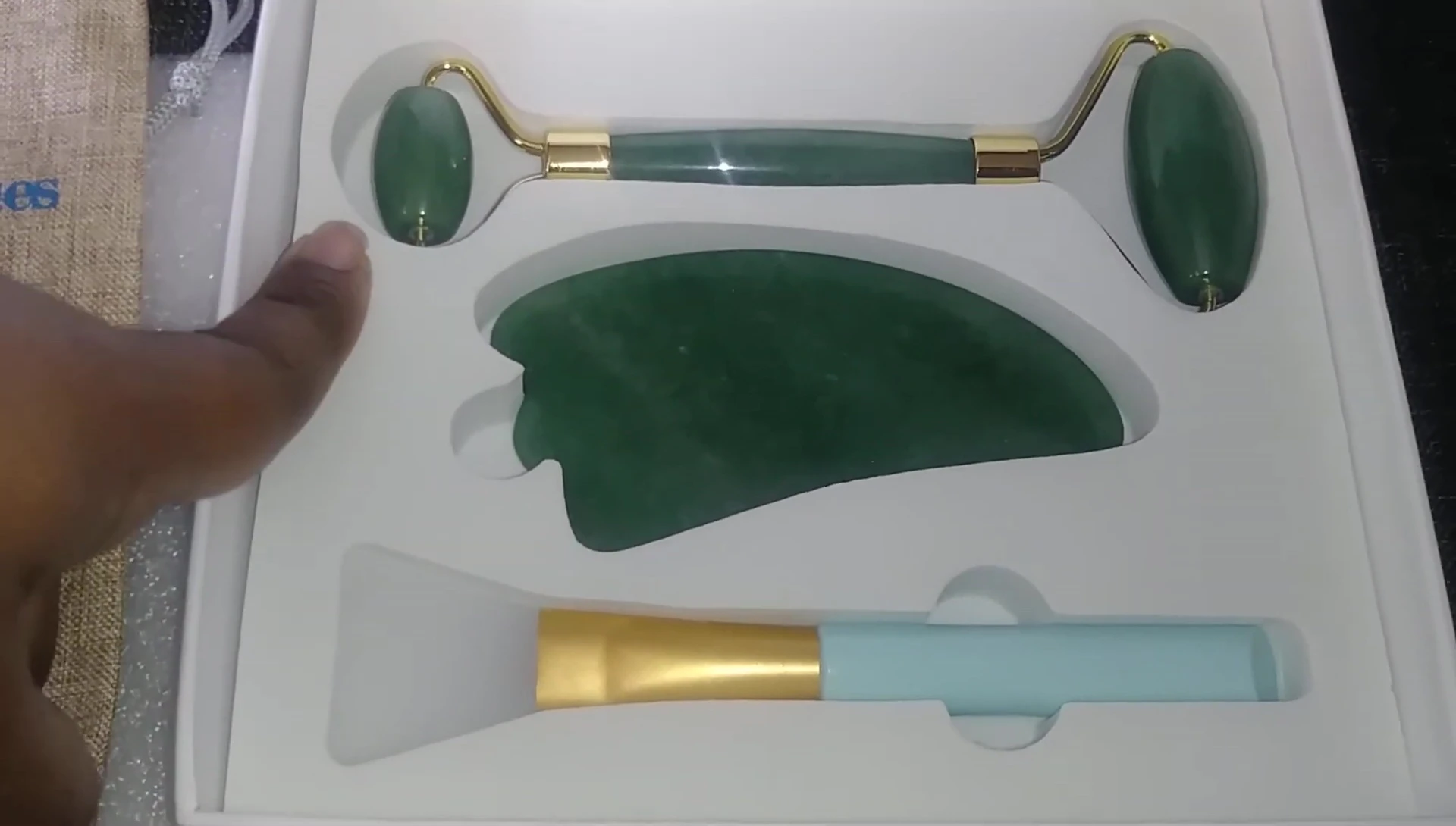 The jade roller being used on the face