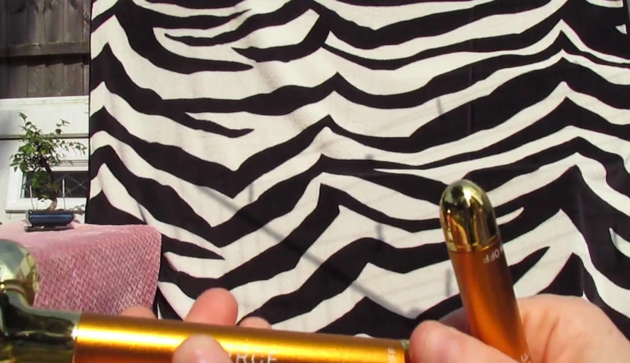 The facial roller with the on/off button visible