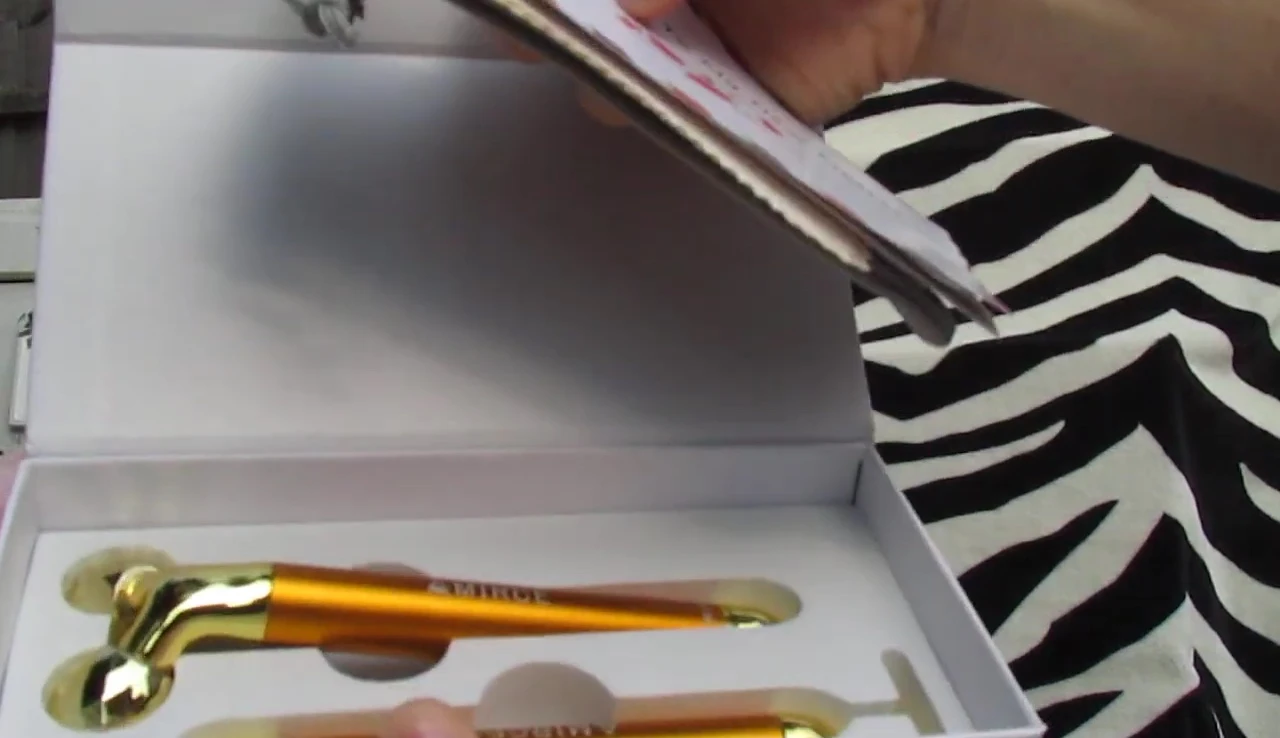 Close-up of the gold-colored facial roller in its packaging