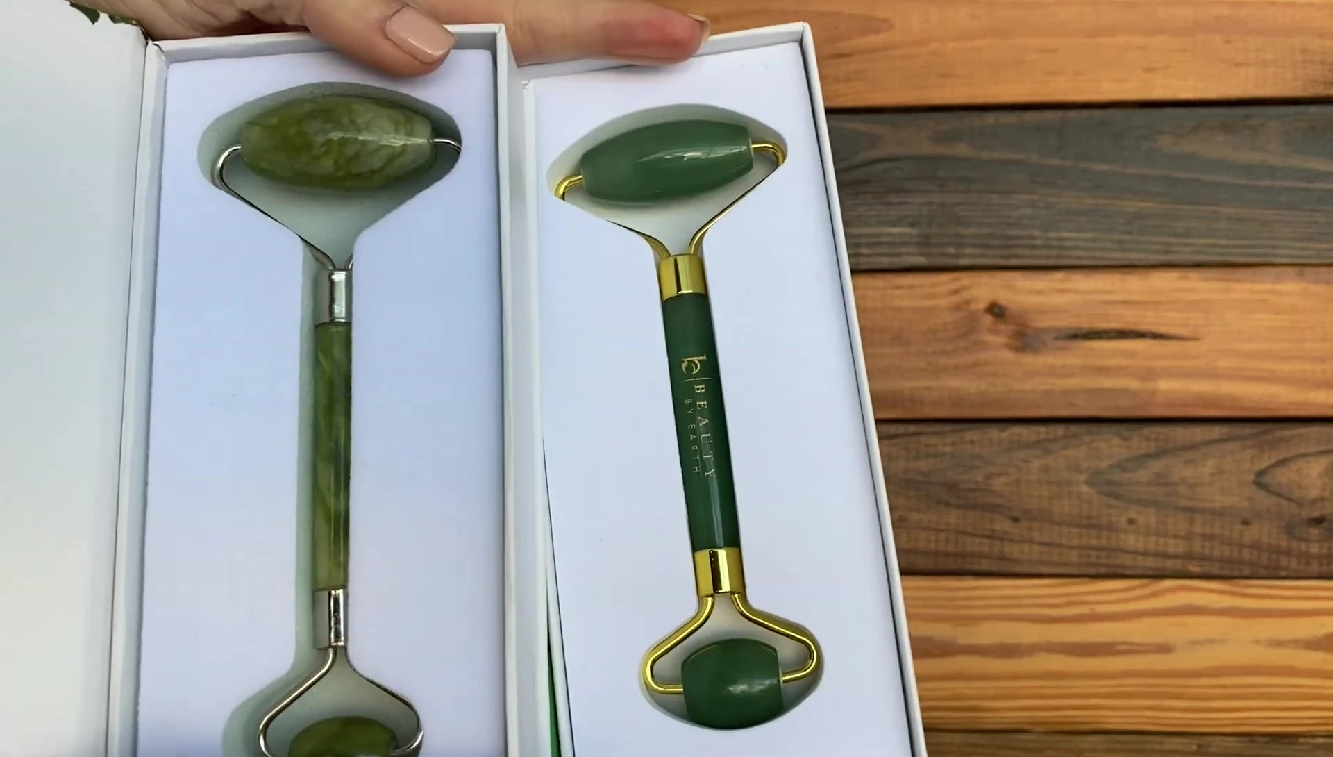 Close-up comparison shot showing the color difference between the two jade rollers.