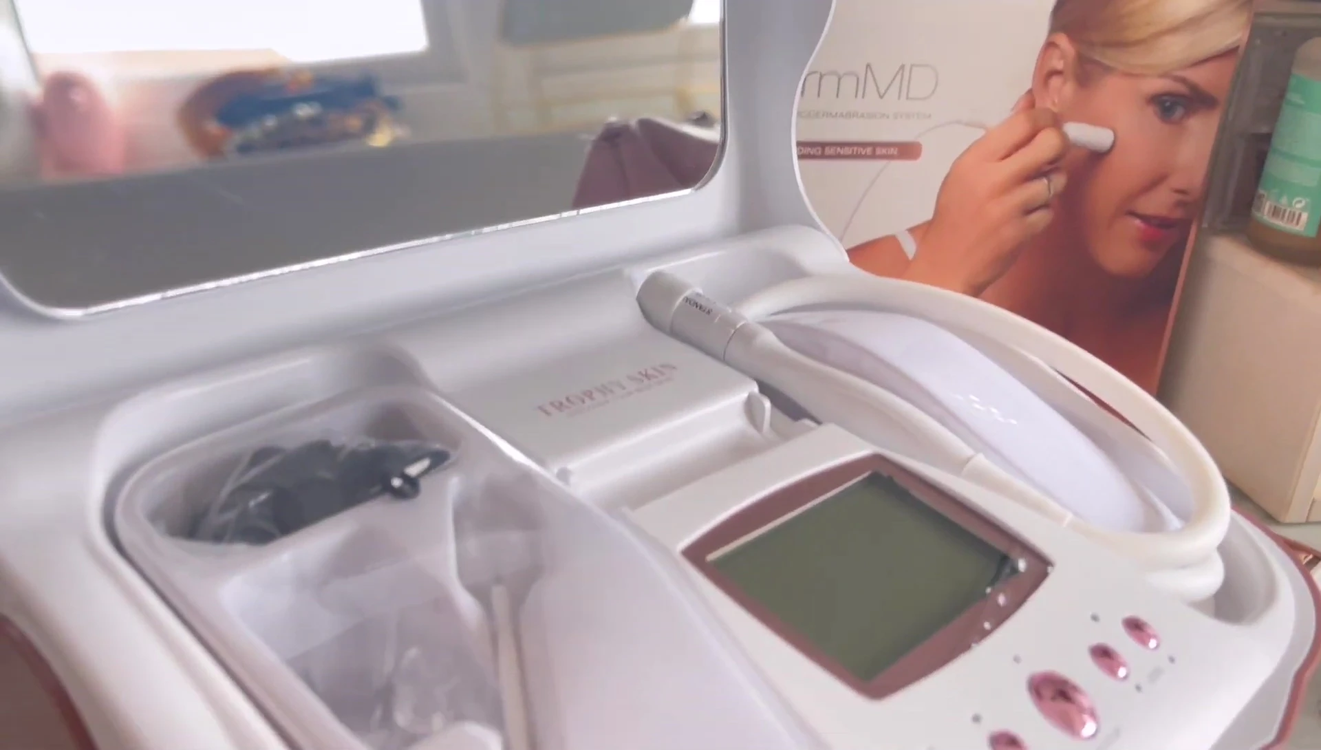 The reviewer holding the device, showing its size and features.