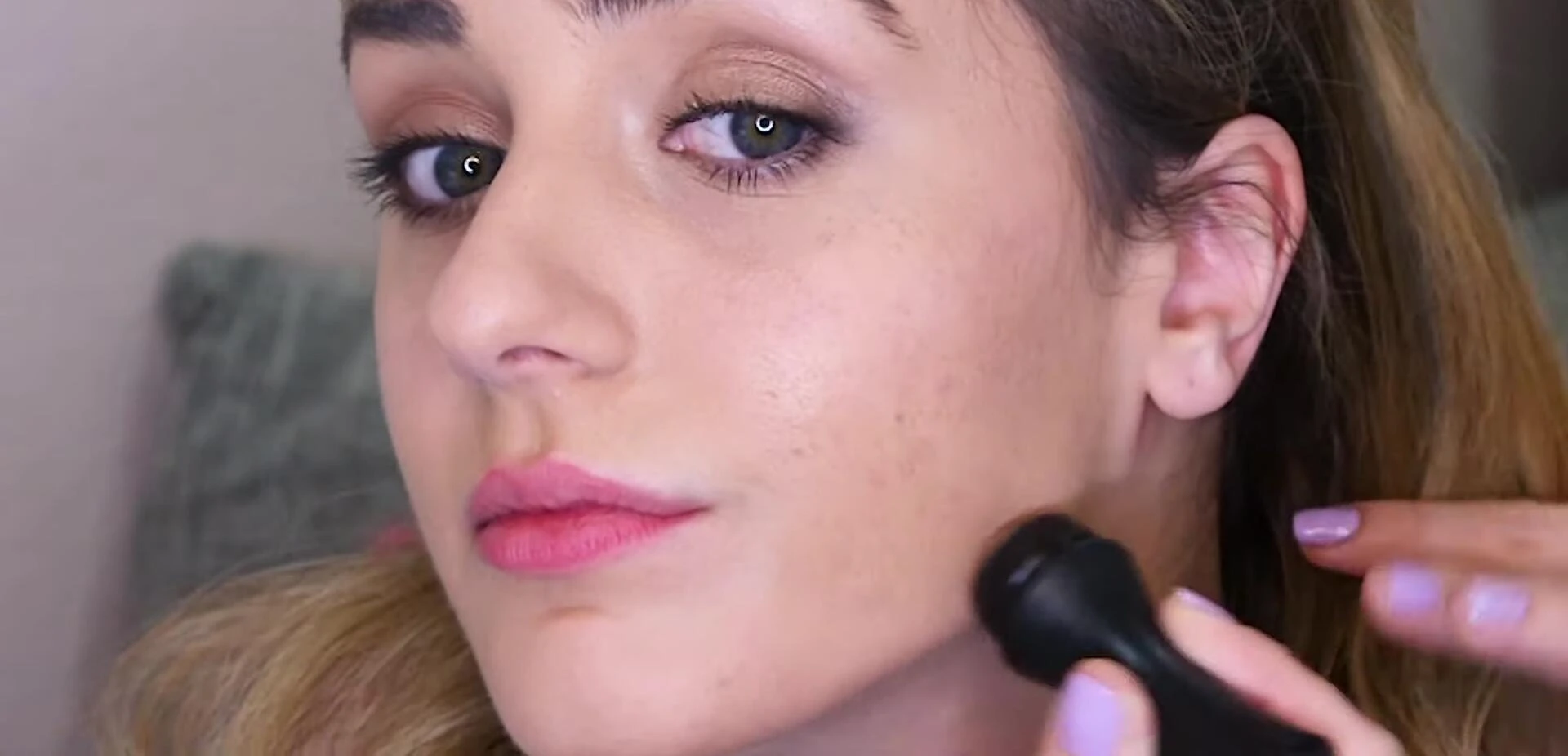 Close-up shot highlighting the minimal disruption to makeup after using the roller.