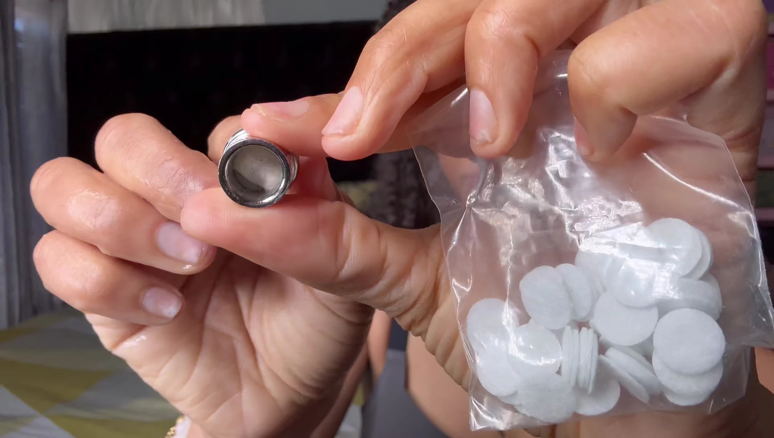 Speaker demonstrating how to clean and replace the cotton filter.