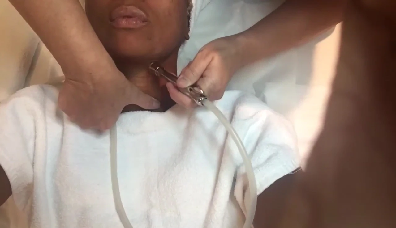 The therapist treating the neck area.
