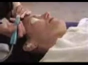 Close-up of esthetician treating the nose area.