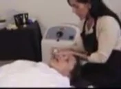 Therapist placing eye pads on the client.