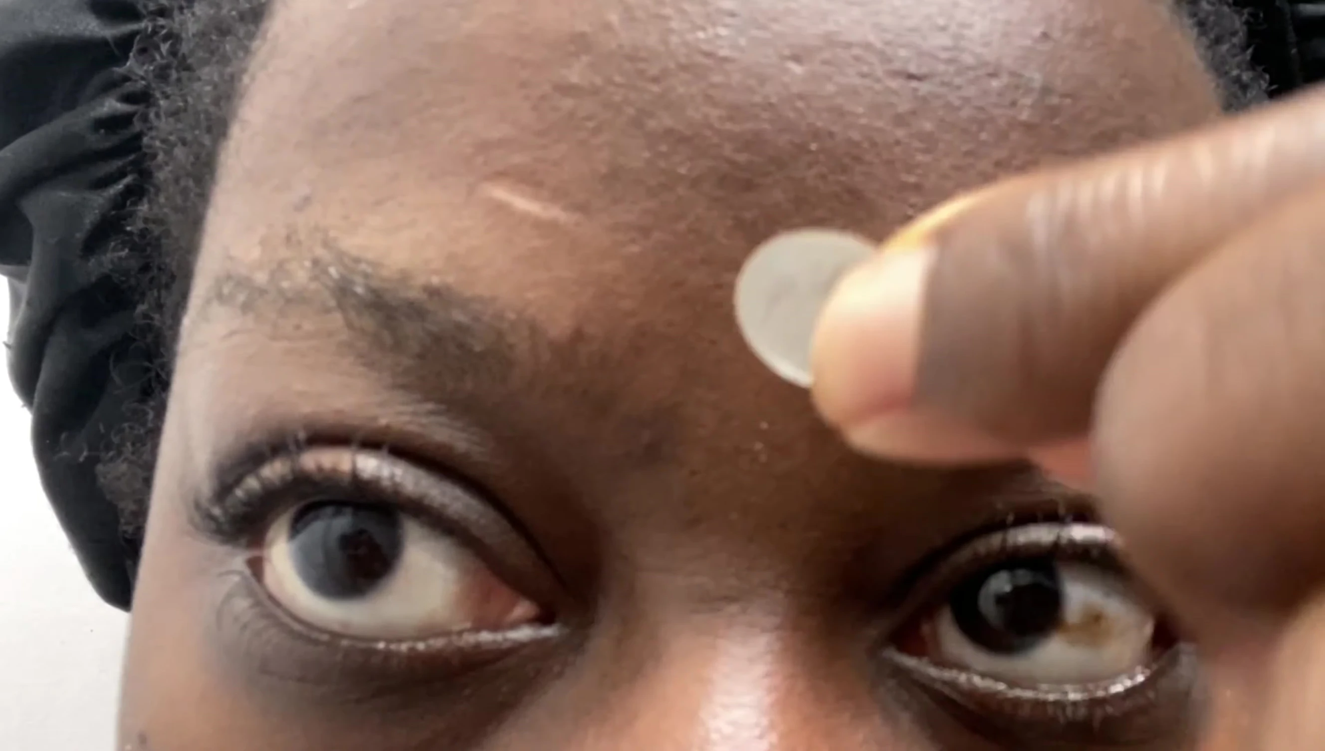 Applying a pimple patch for the second night.