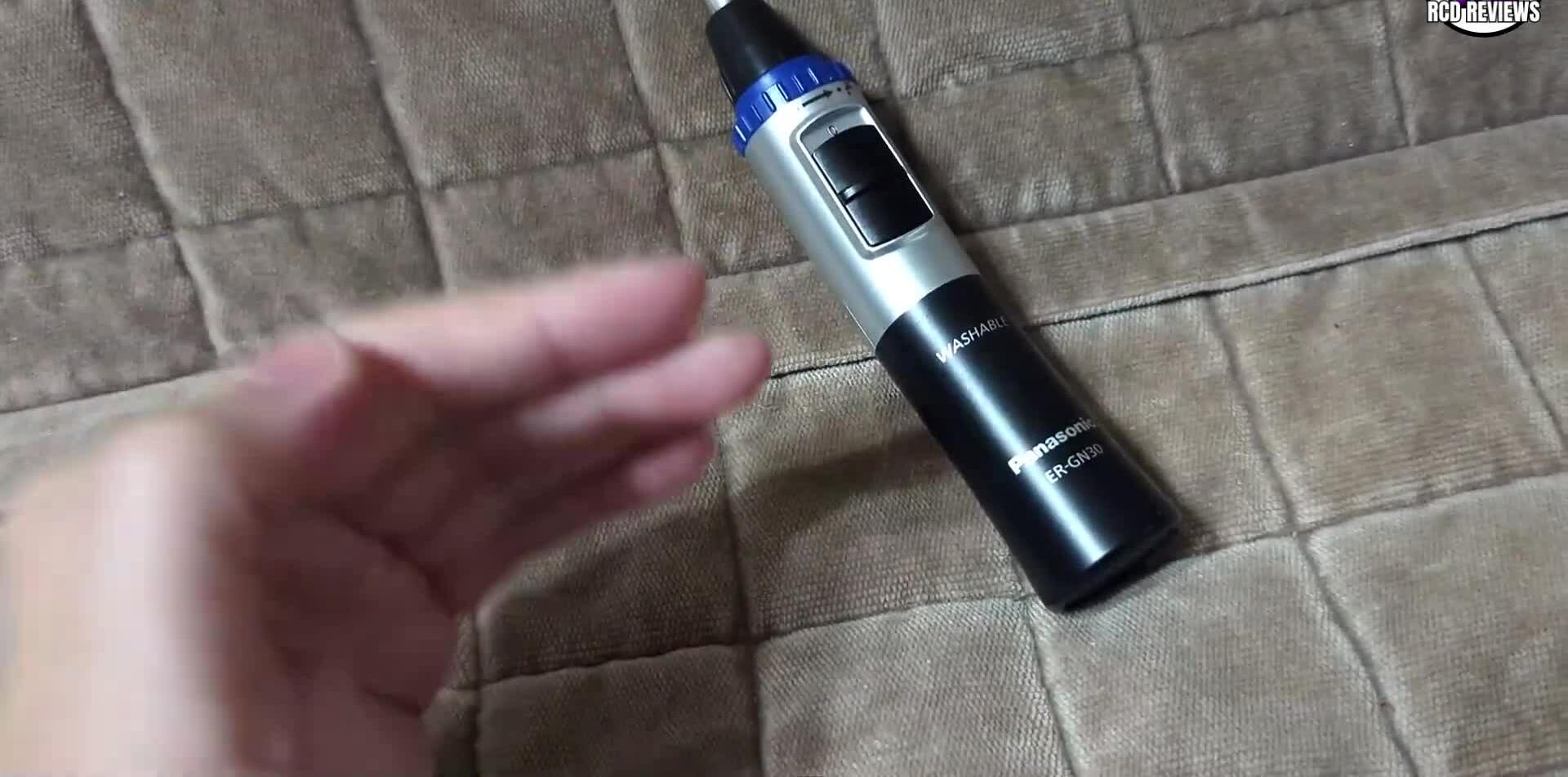 The Panasonic ER-GN30-K trimmer held in hand.