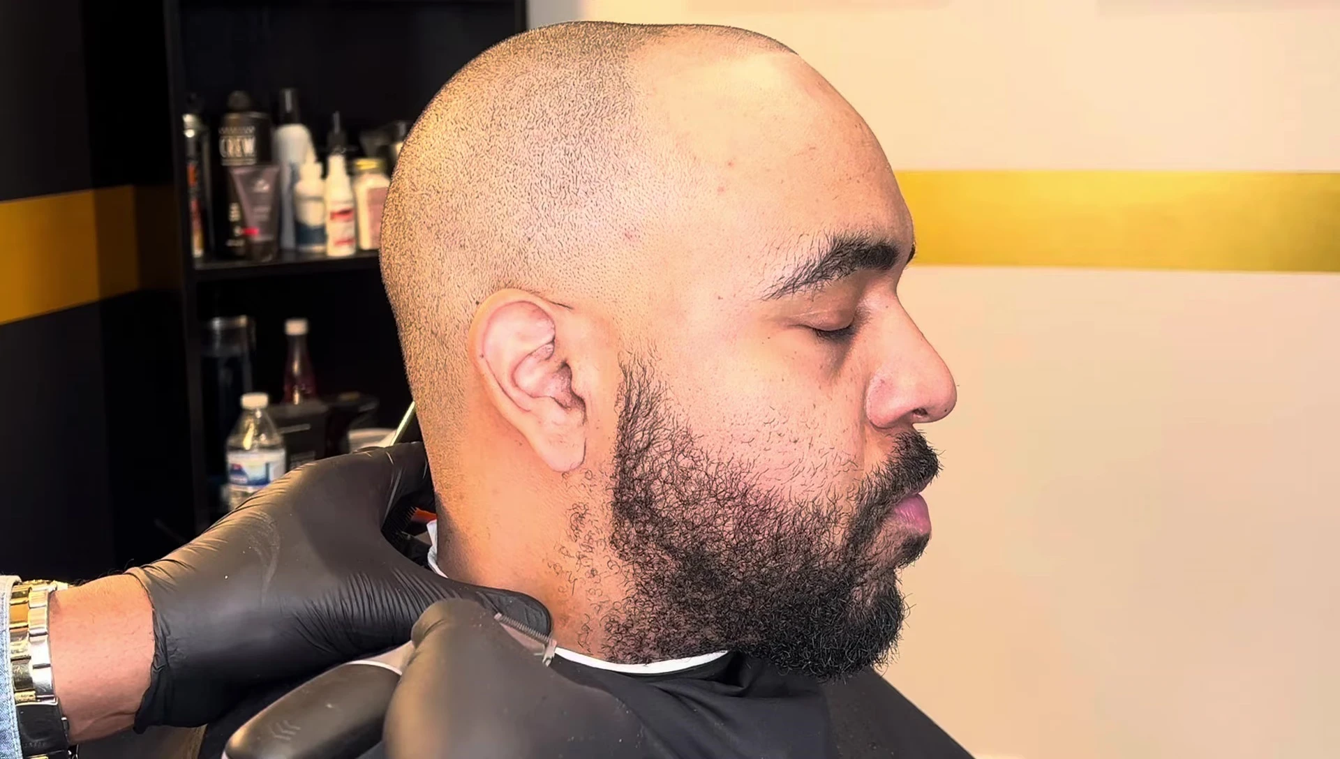 The trimmer in action, cutting the client's beard.