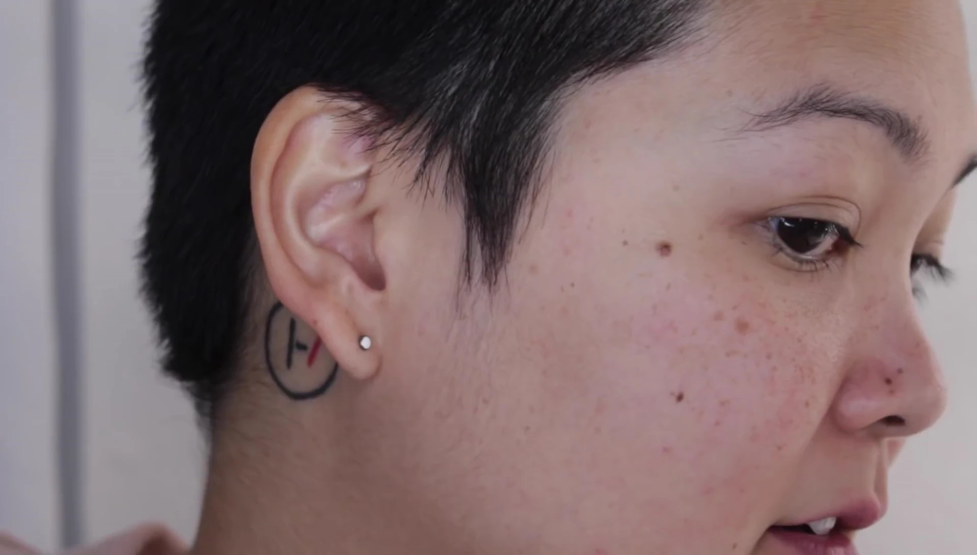 The reviewer using the device on their neck.