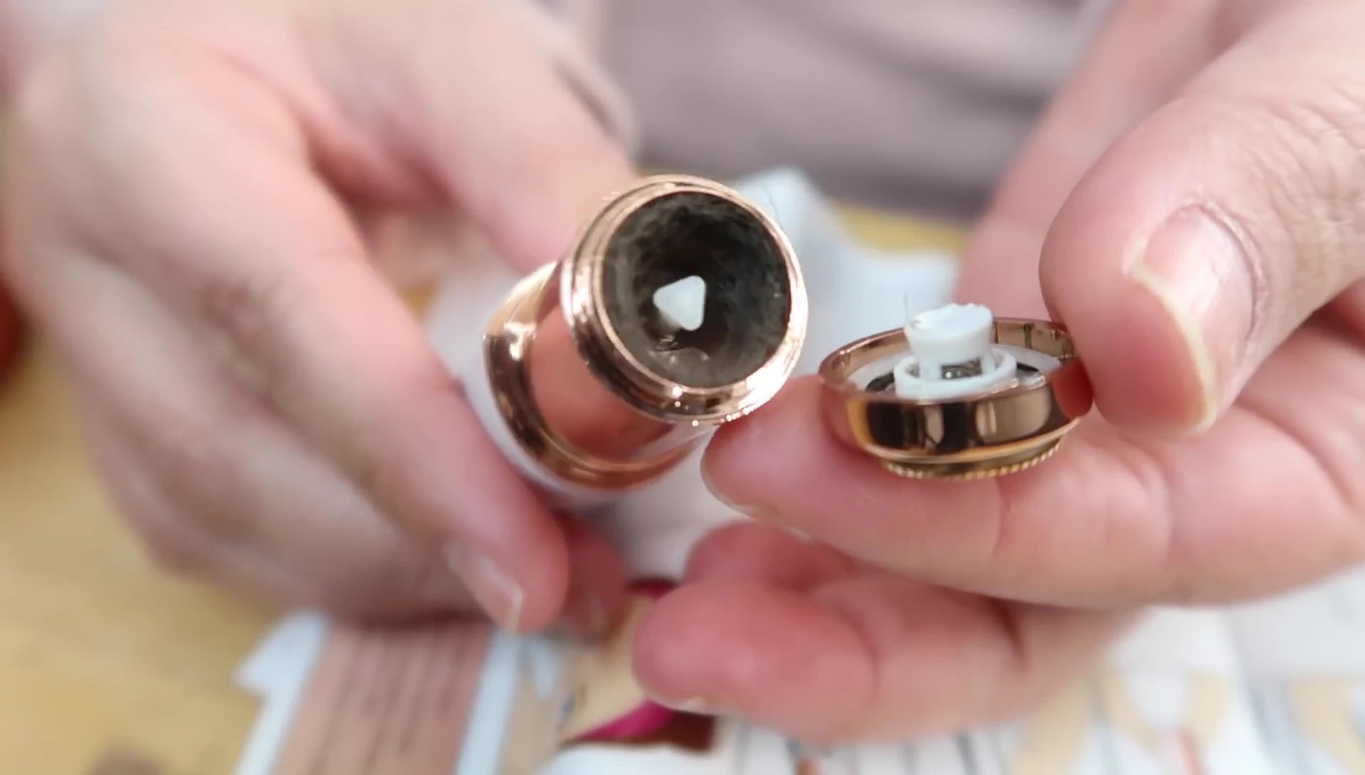 The reviewer showing the collected hair after using the device