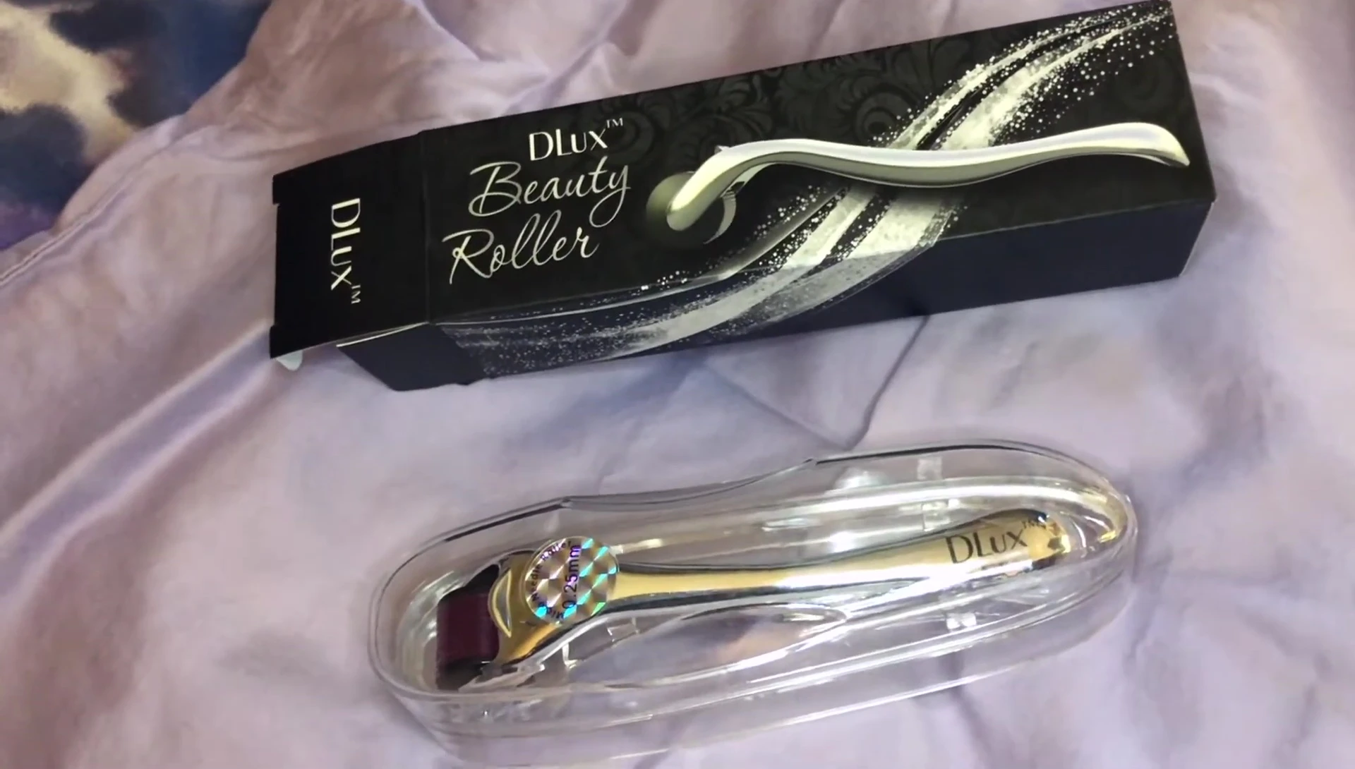 The reviewer holding the DLux Beauty Roller.