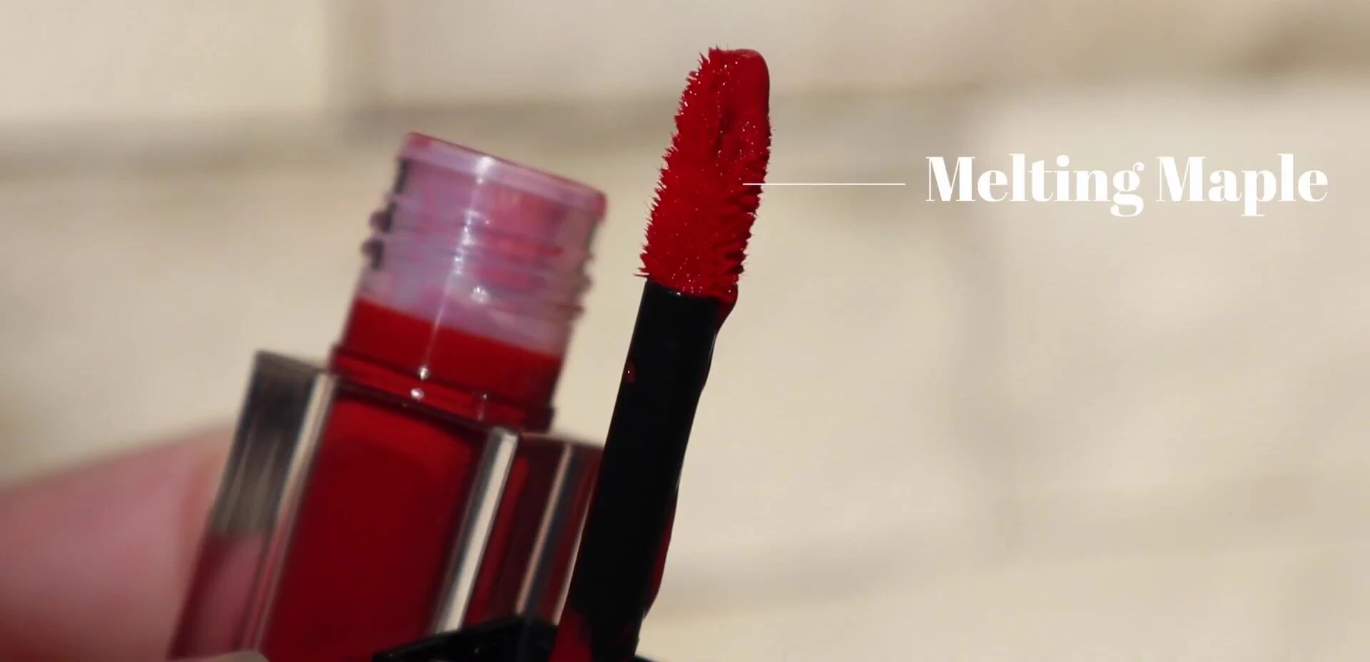 The lip tint being applied.